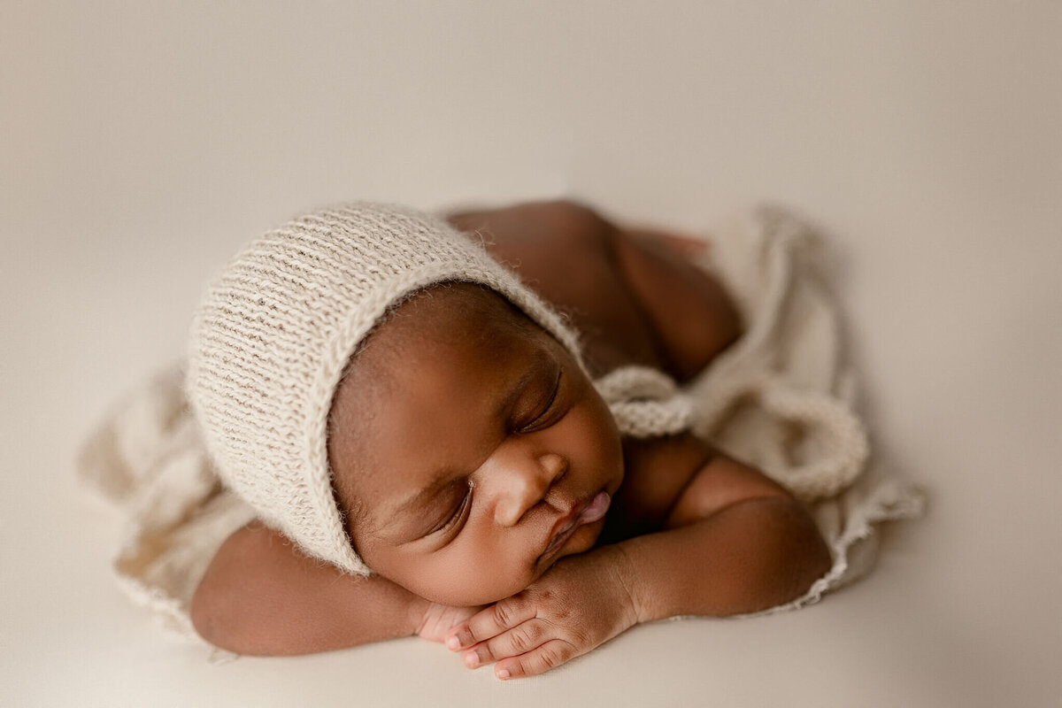 baby sleeping with knit bonnett