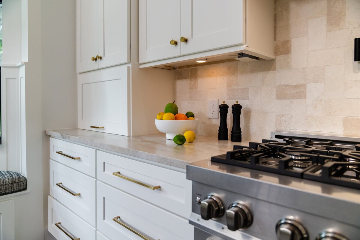 dewine design interiors farmhouse modern kitchen with gold hardware and bowl of lemons and limes on counter