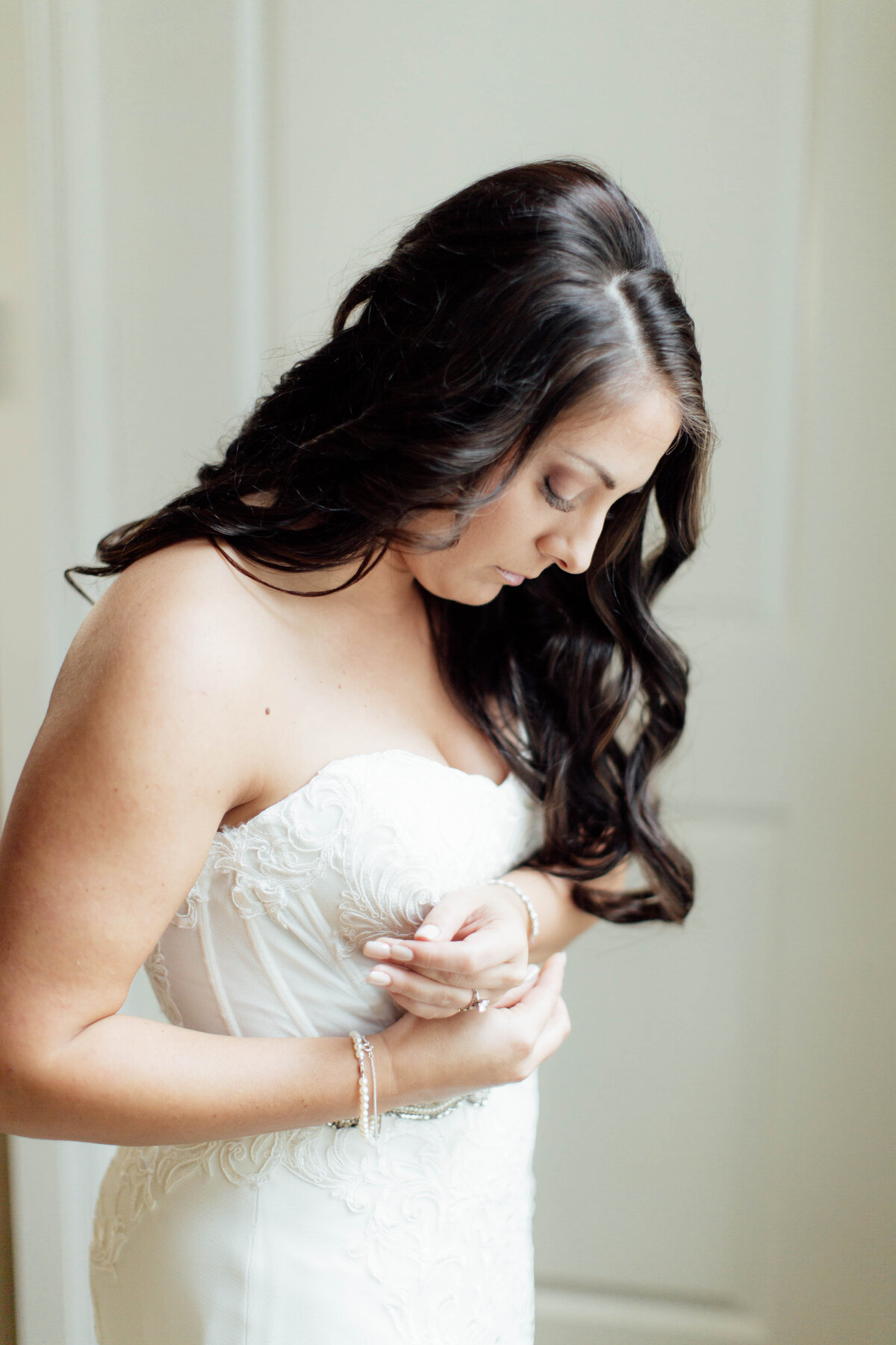 Bride putting on bracelet. 