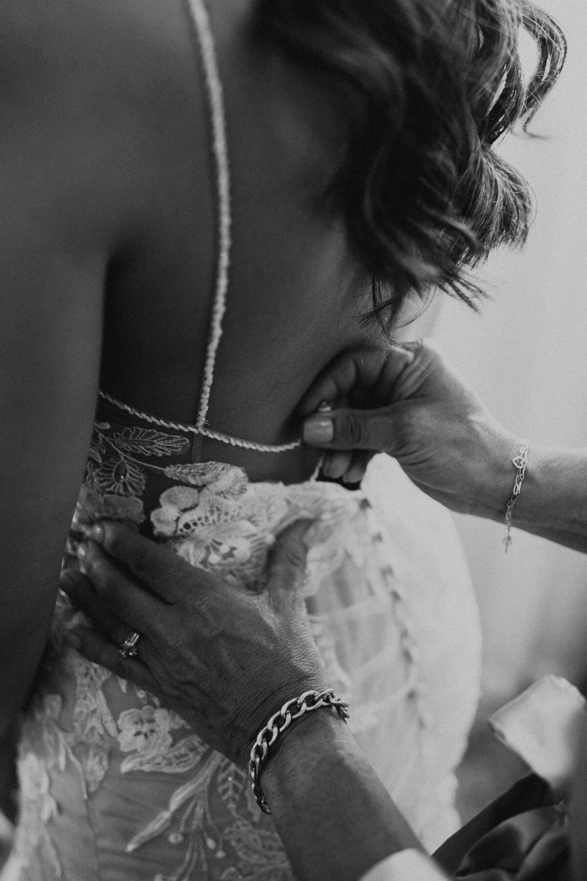 Mother fixes her daughters wedding dress on her wedding day