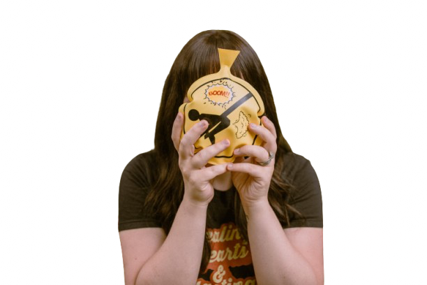 Woman holding a whoopie cushion over her face