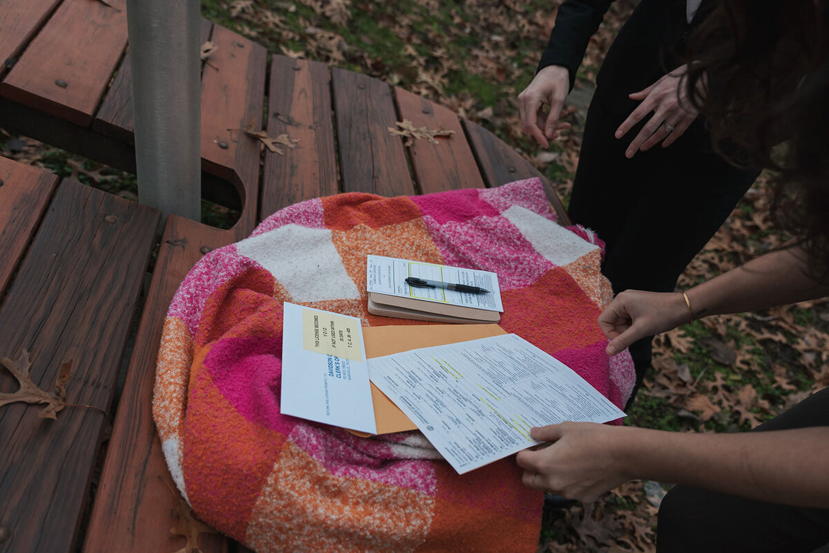 Legal marriage documents sit atop a lesbian flag blanket
