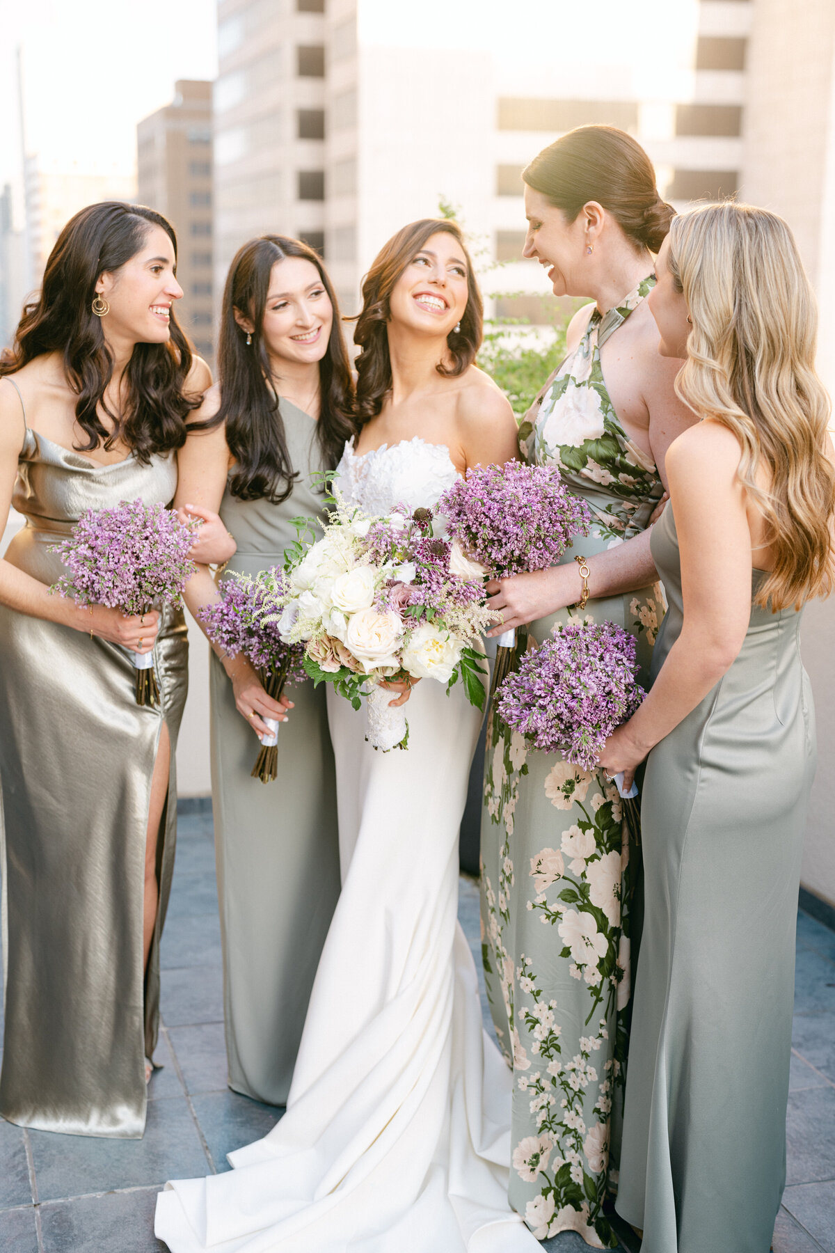 Bridesmaids in sage green and floral dresses