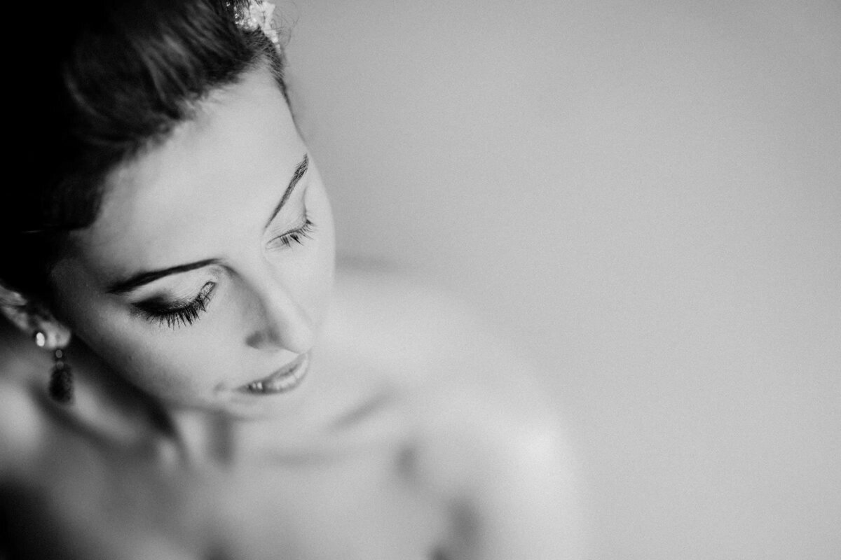 A soft-focus portrait of a bride looking downward