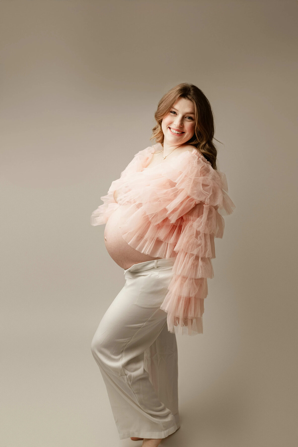 Soft pink ruffle top maternity portrait at Duehr Photography in Maple Grove studio 