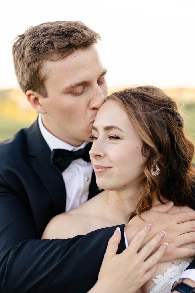 Bride and groom embracing, , captured by Lorissa Lee Photography. Featured on Brontë Bride.