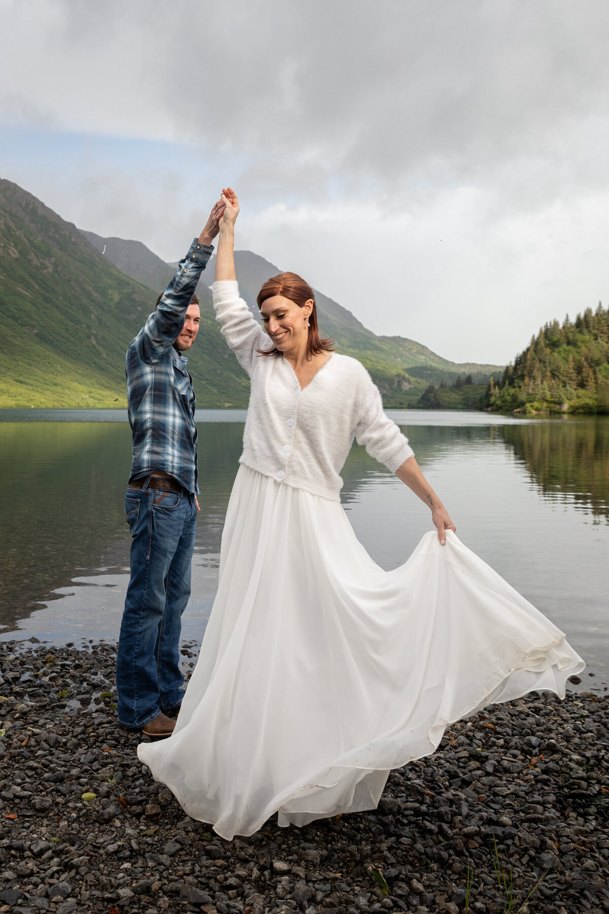 A groom twirls his bride on their elopement day in Alaska.