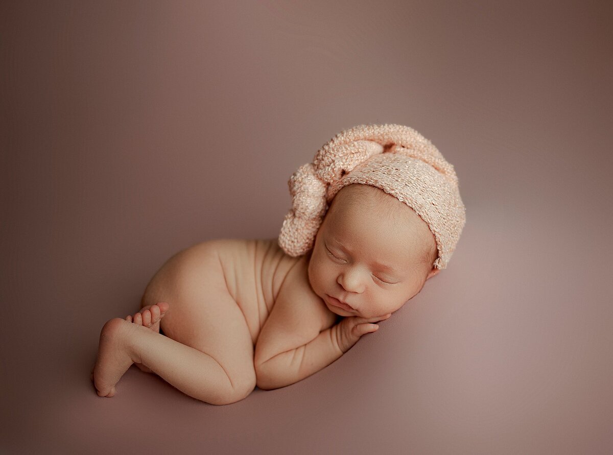 Peacefully sleeping newborn posed in custom set at Haili Barton Photography’s Pflugerville studio
