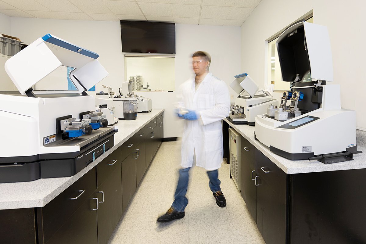 scientist waling through a lab of machines