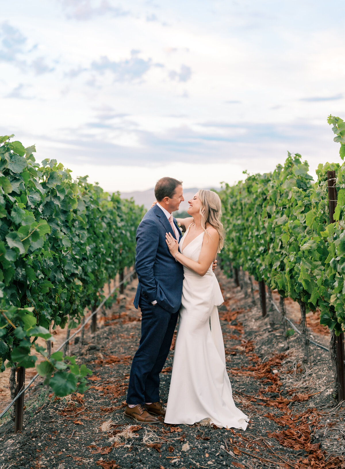 bride and groom pose in Vineyard at Greengate Ranch wedding