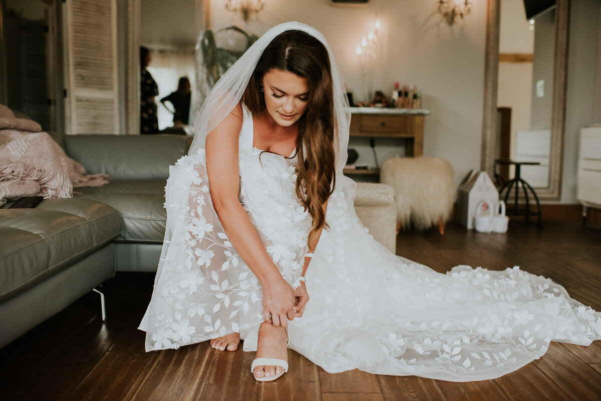 Bride putting on her shoes