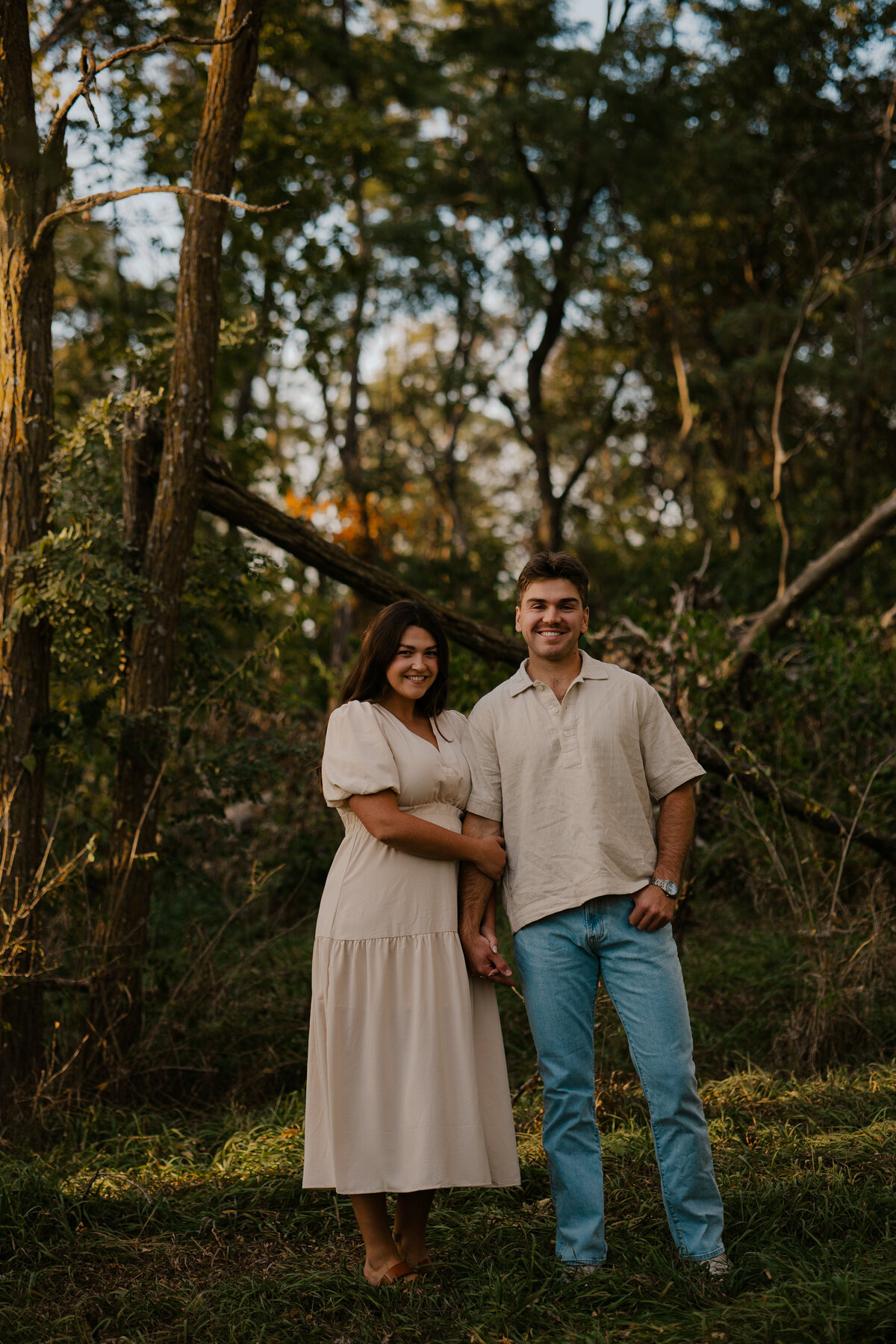 Couple's engagement session in Omaha during golden hour, surrounded by warm fall foliage – captured by Tori Nichole Photography. Authentic, romantic moments in a stunning autumnal setting, reflecting the beauty of the season and their love story.