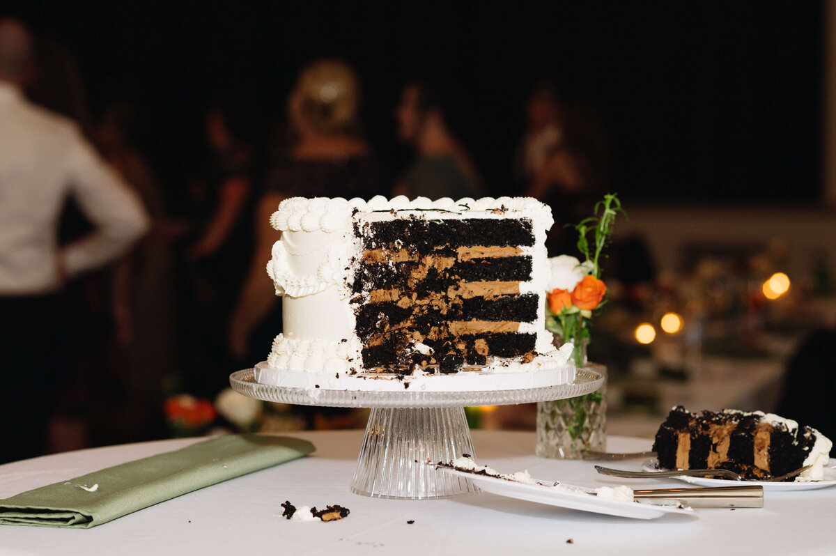 Virginia wedding photographer captures wedding cake after it was cut sitting on a table at the reception