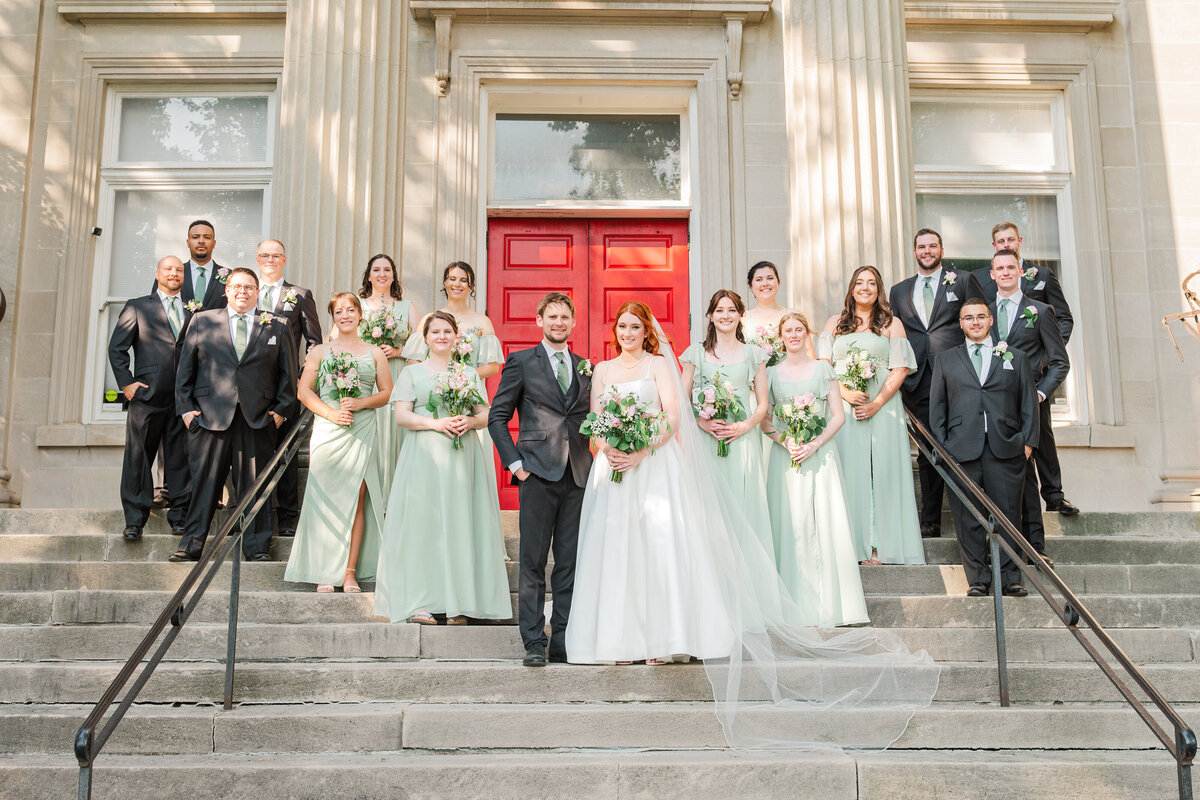 bridal party smiling on stairs of beautiful venue in downtown lexington