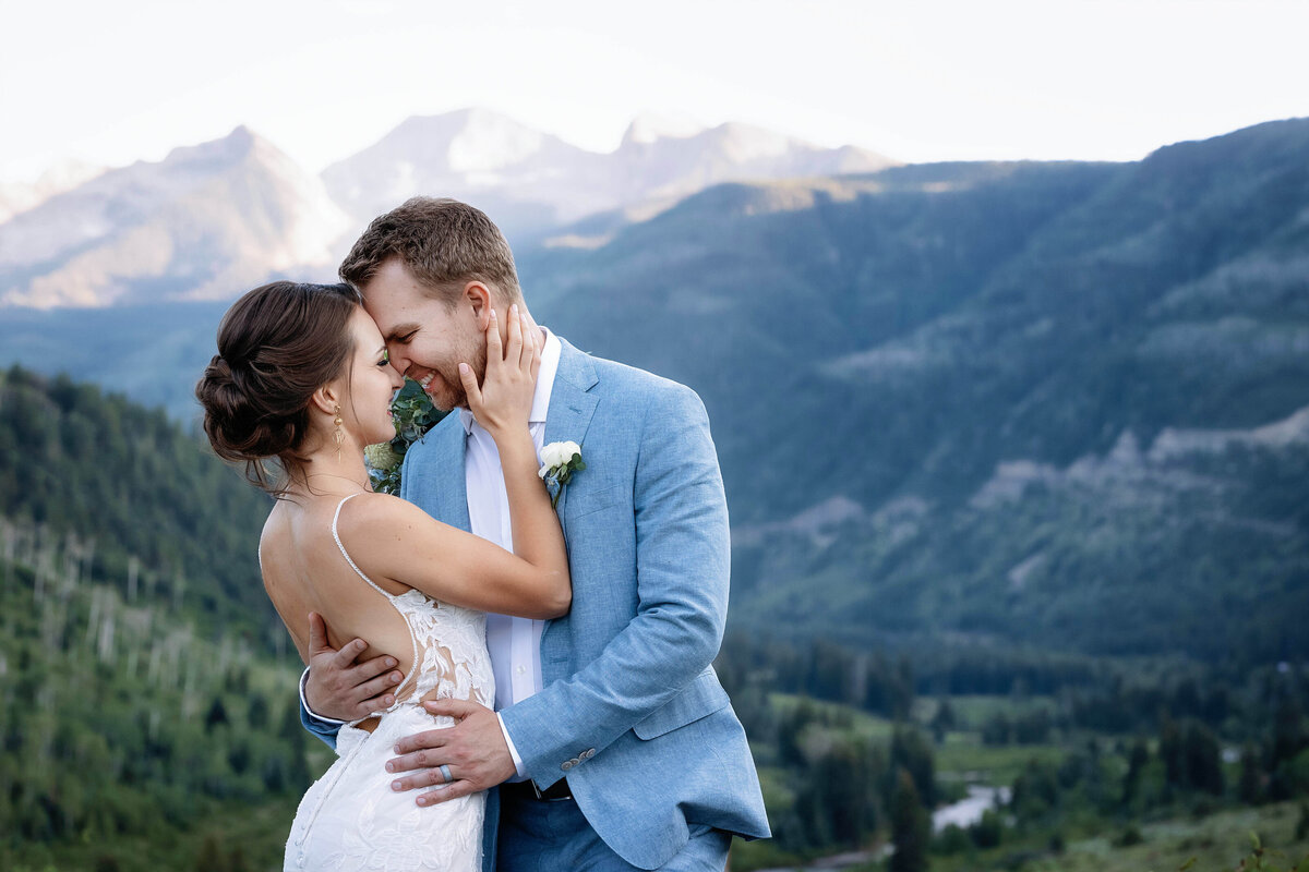 Bride looks up with a nice smile at her groom, as they walk down an aspen tree lined boardwalk in their Aspen, Colorado wedding,