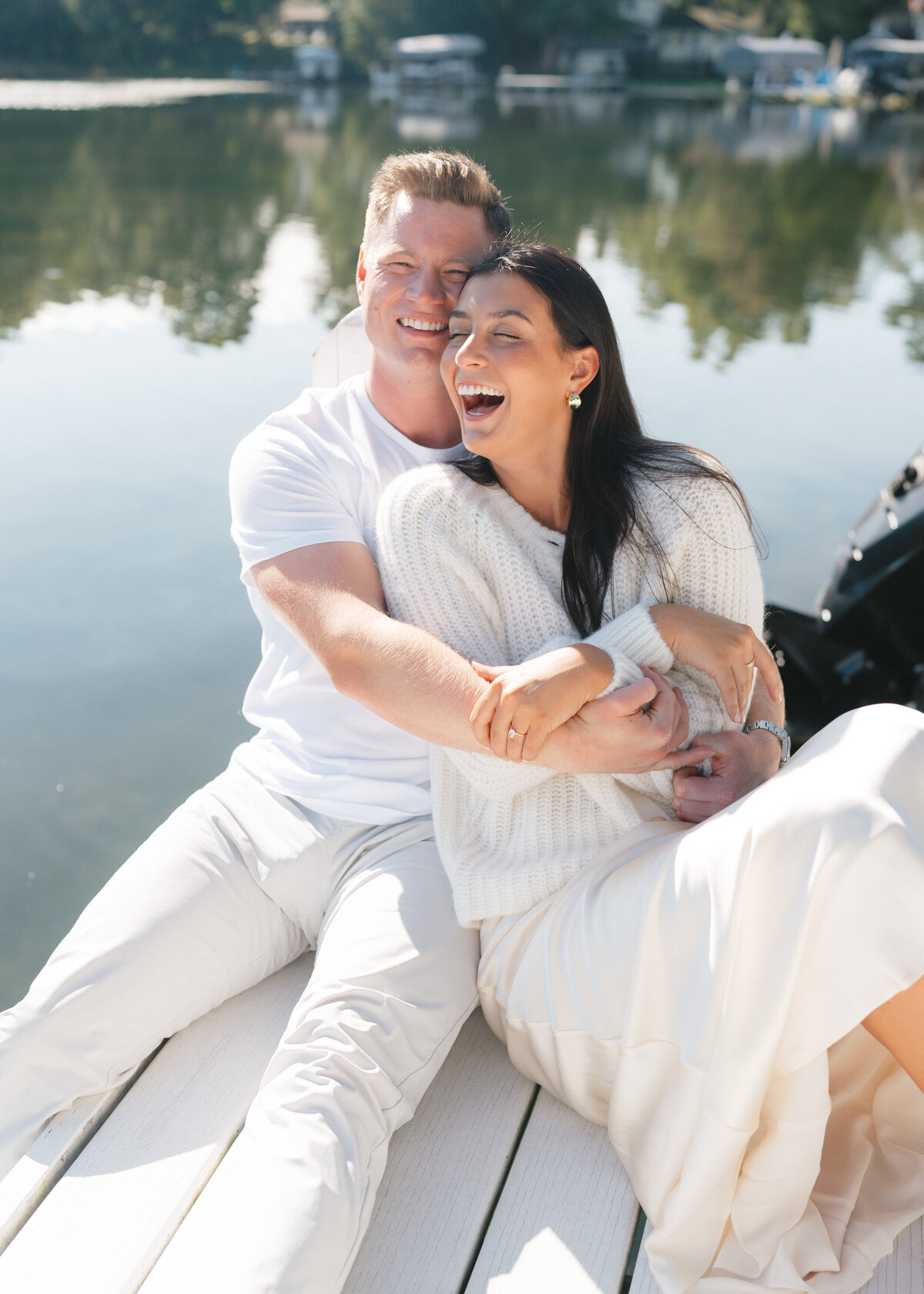 couple sitting on dock on lake beulah