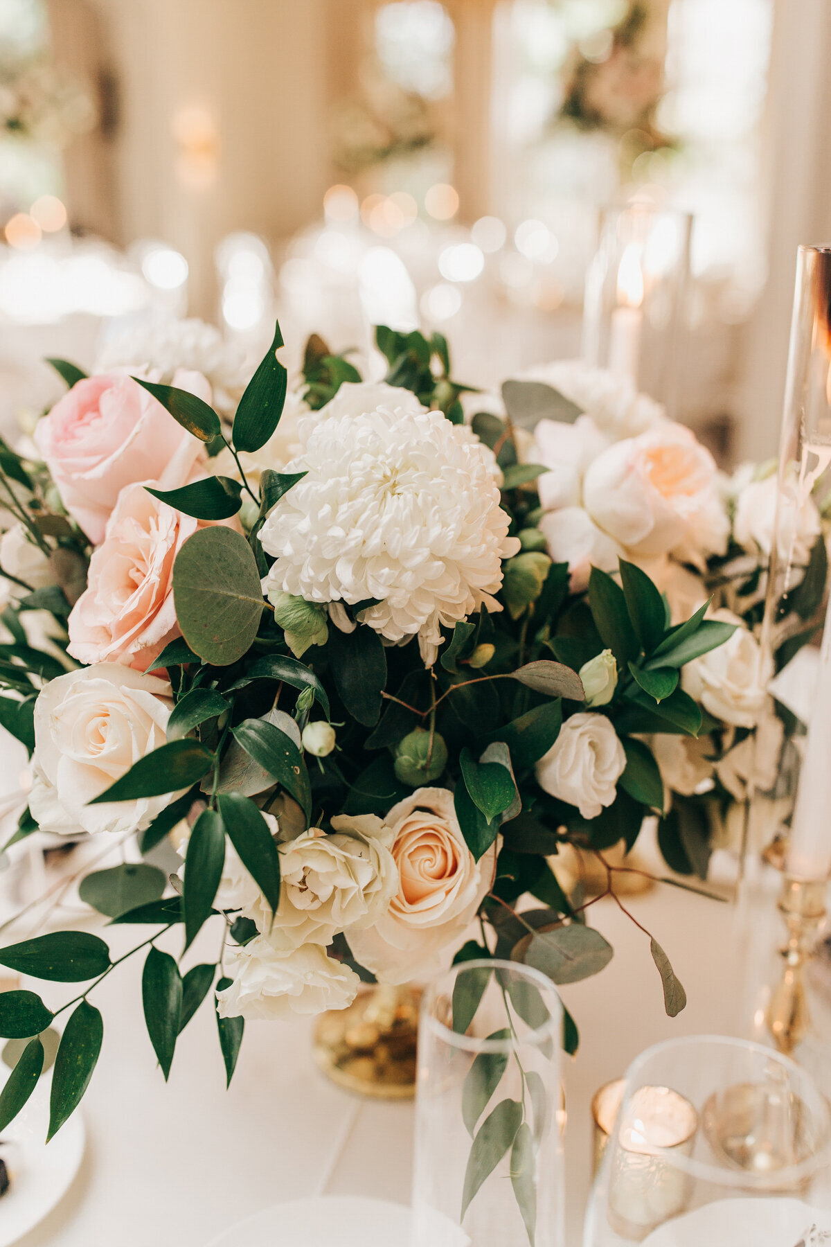 Eucalyptus, roses, and chrysanthemums in luxurious wedding centre pieces