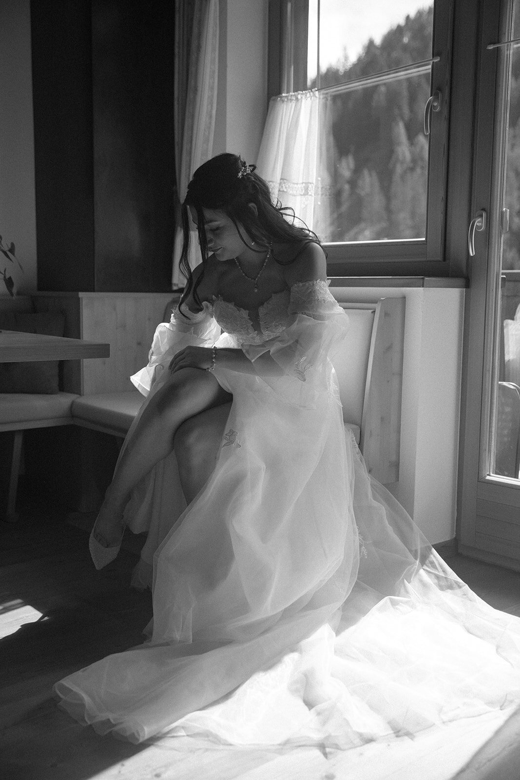 lake braies italy bride gets ready and puts shoes on 