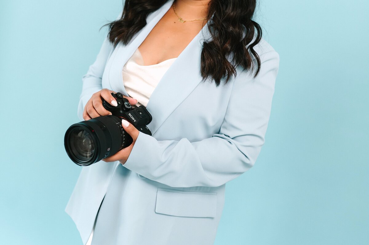 Lyn smiling at camera with laptop