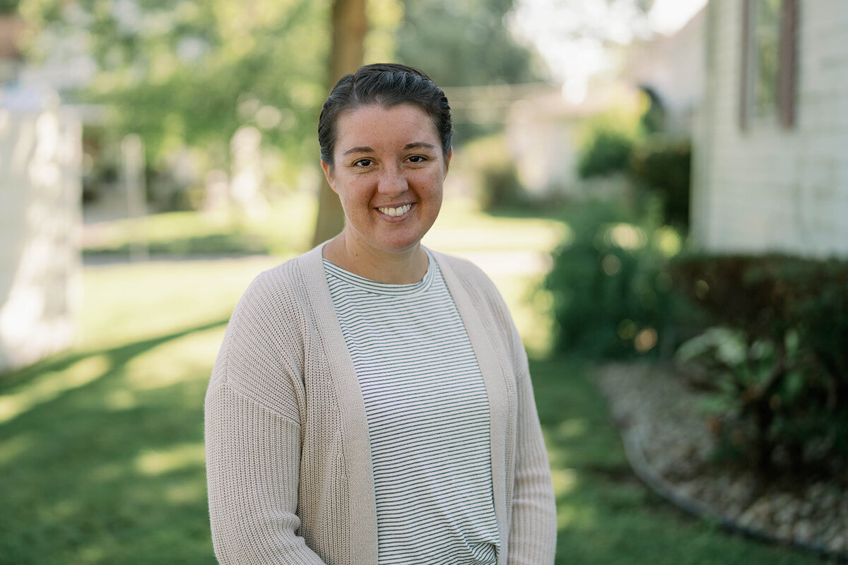 Professional headshot of a team member standing outside during a branding session for a planner company in Indiana.