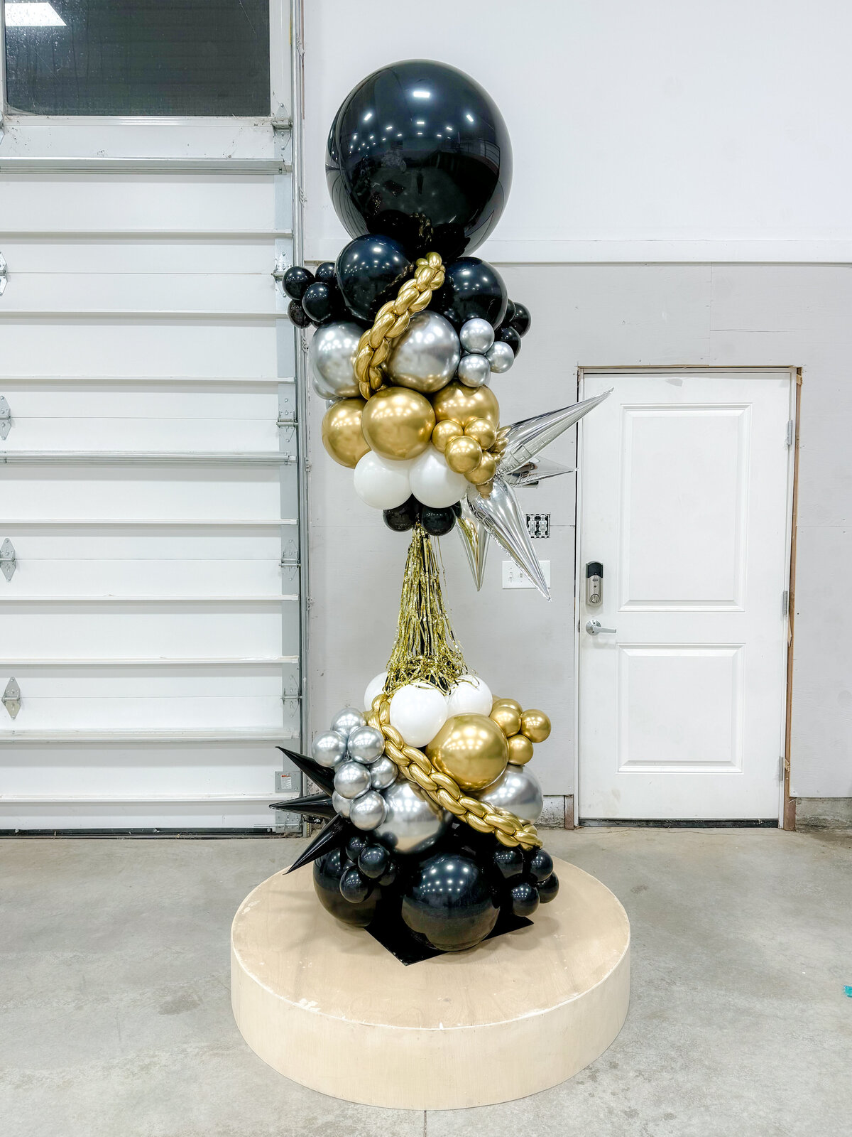 black gold and silver balloon tower
