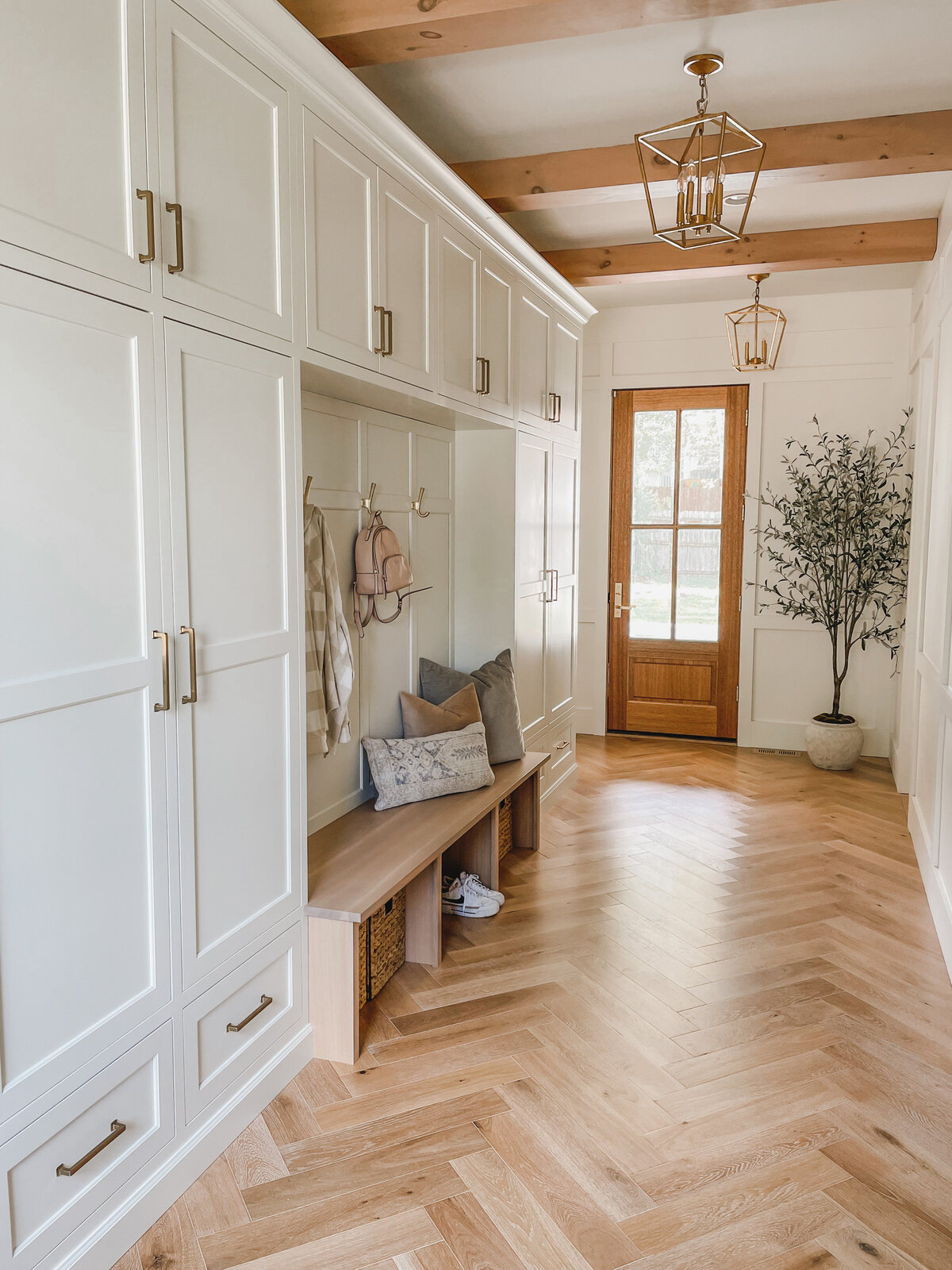 The oversize mudroom includes plenty of storage in custom cabinets and room to hang coats and store shoes