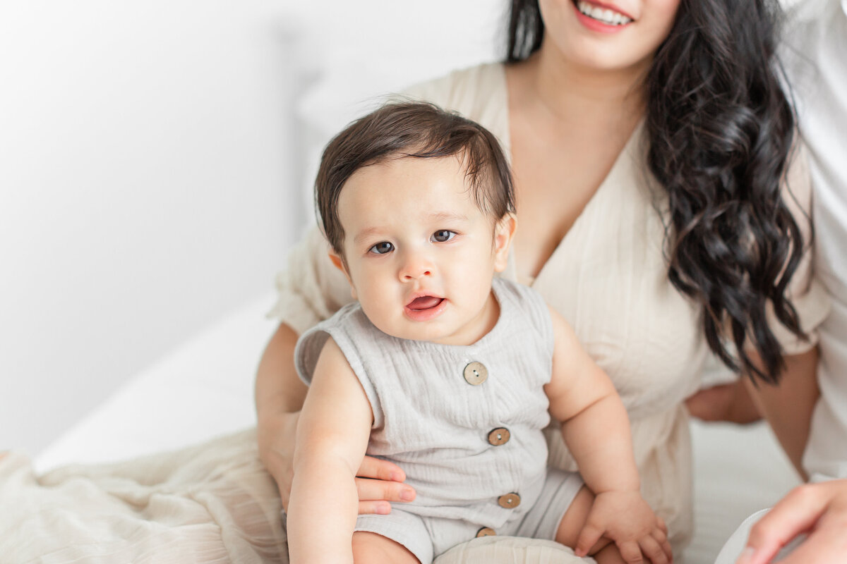 A baby boy in his mother's arms at their northern virginia family photography photo session