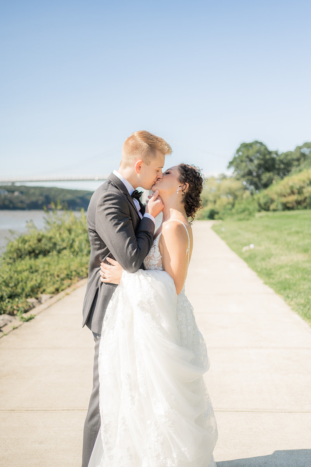 bride and groom enjoy kiss during wedding day portraits in ny