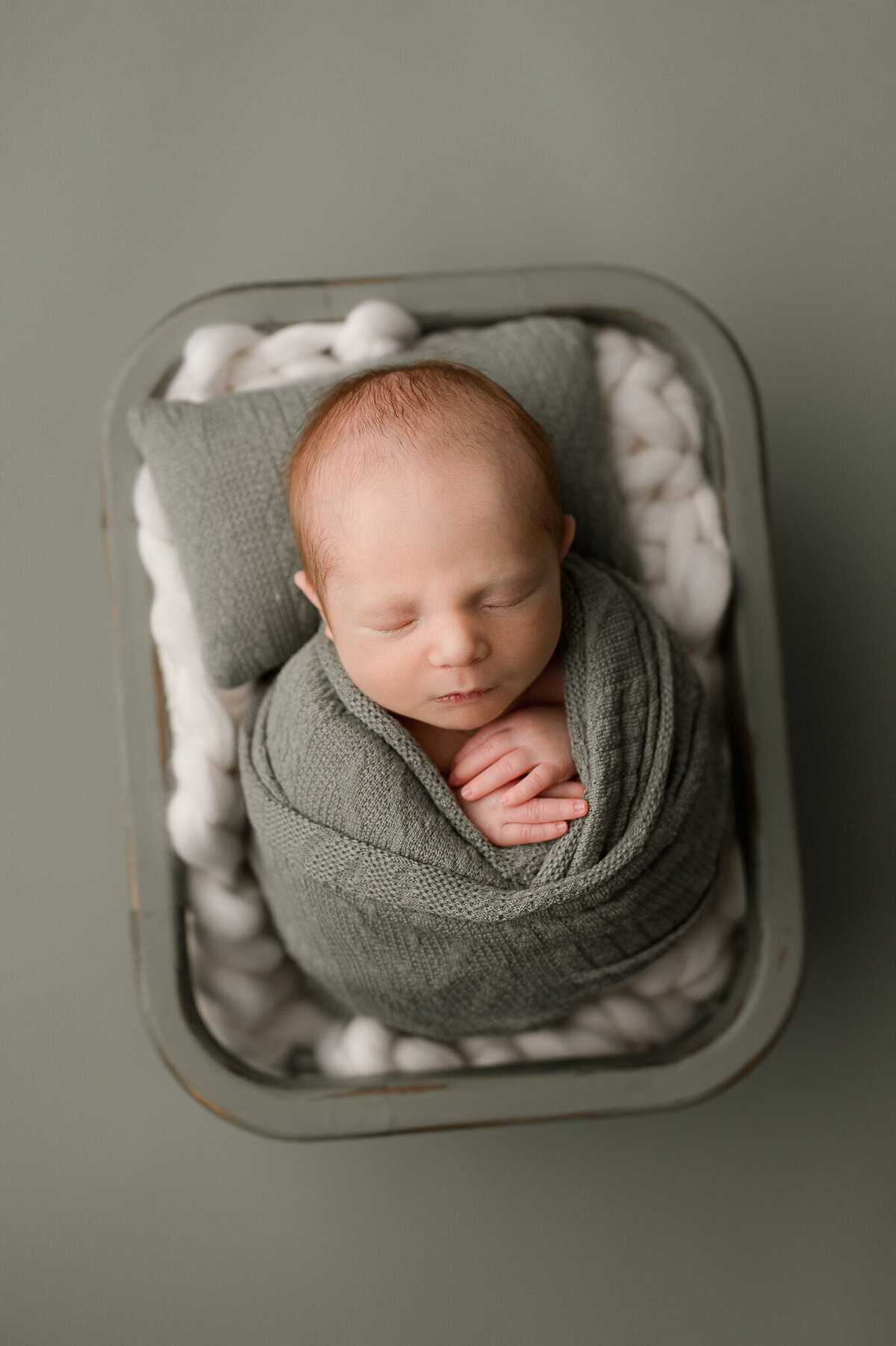 Newborn swaddled posed in luxury studio swanton ohio