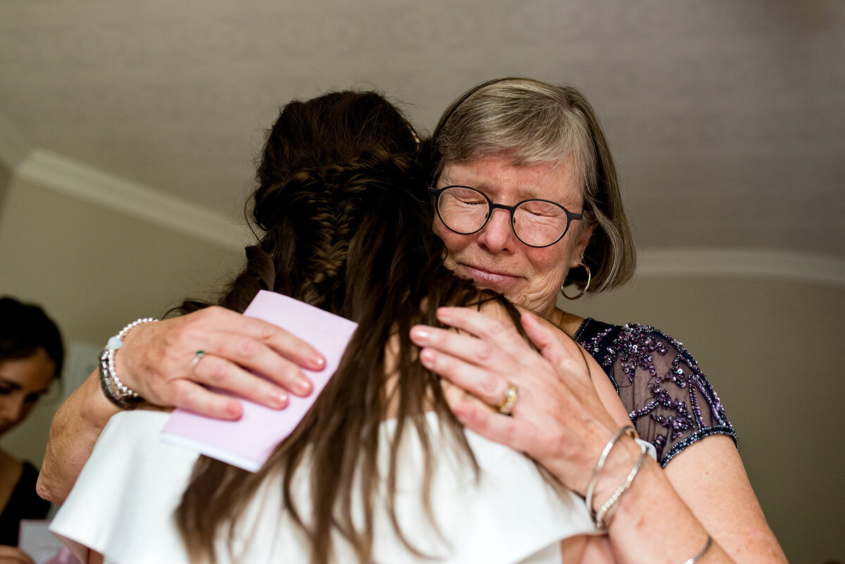 Mother hugging daughter on her wedding day  Johnville Quebec