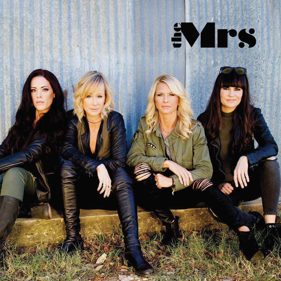 Self Titled Album Cover Female Band The Mrs four members sitting on low wood bench in long grasses metal wall behind them