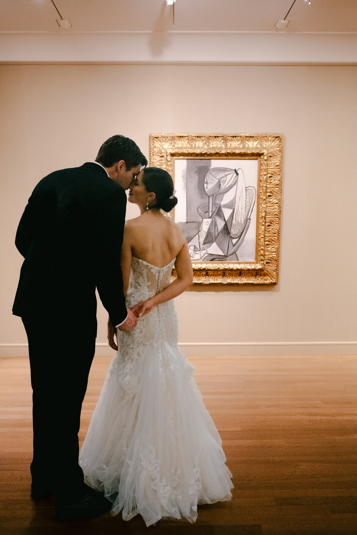 wedding couple standing in front of a Picasso  painting