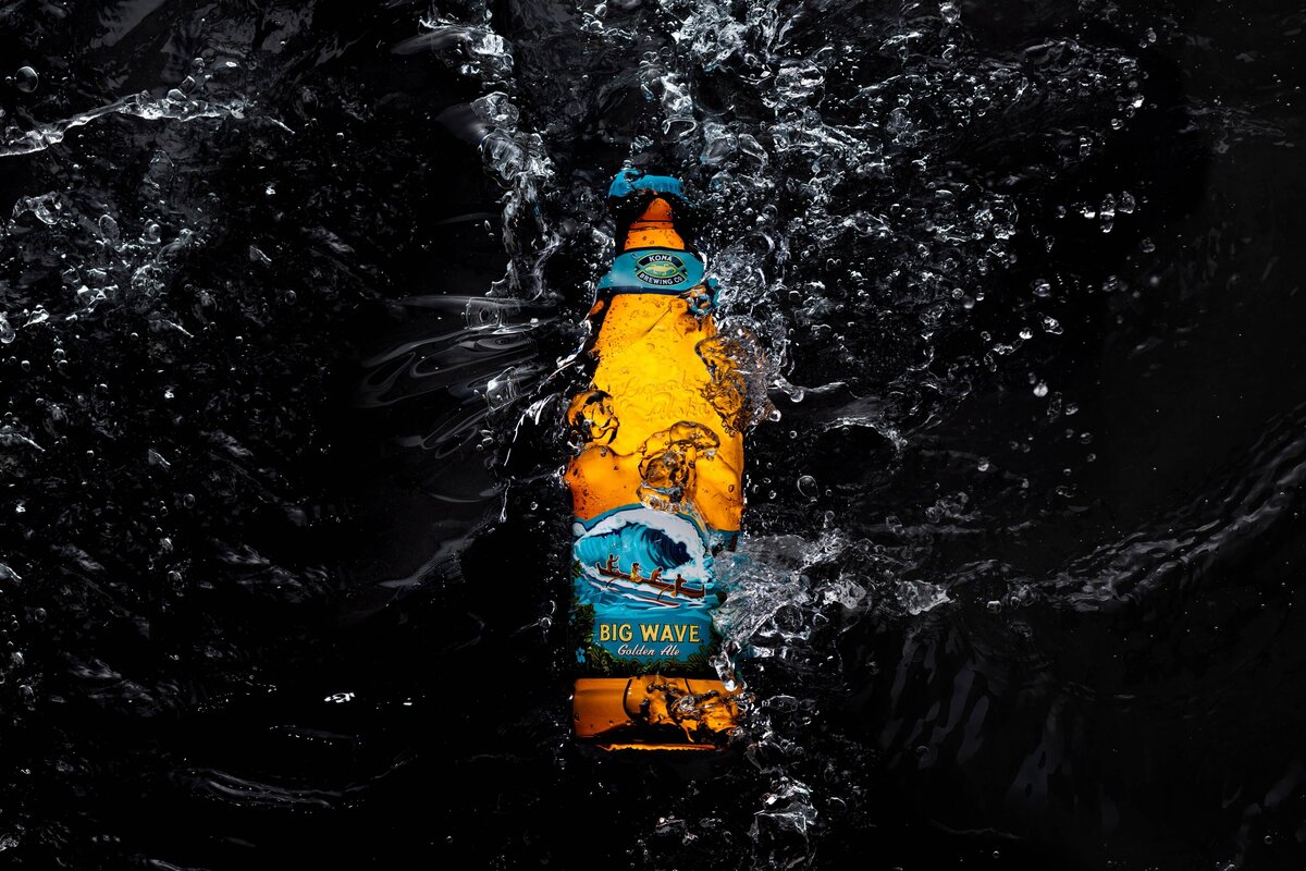 Kona Brewing Big Wave Creative Product photo with liquid wave crashing into illuminated bottle
