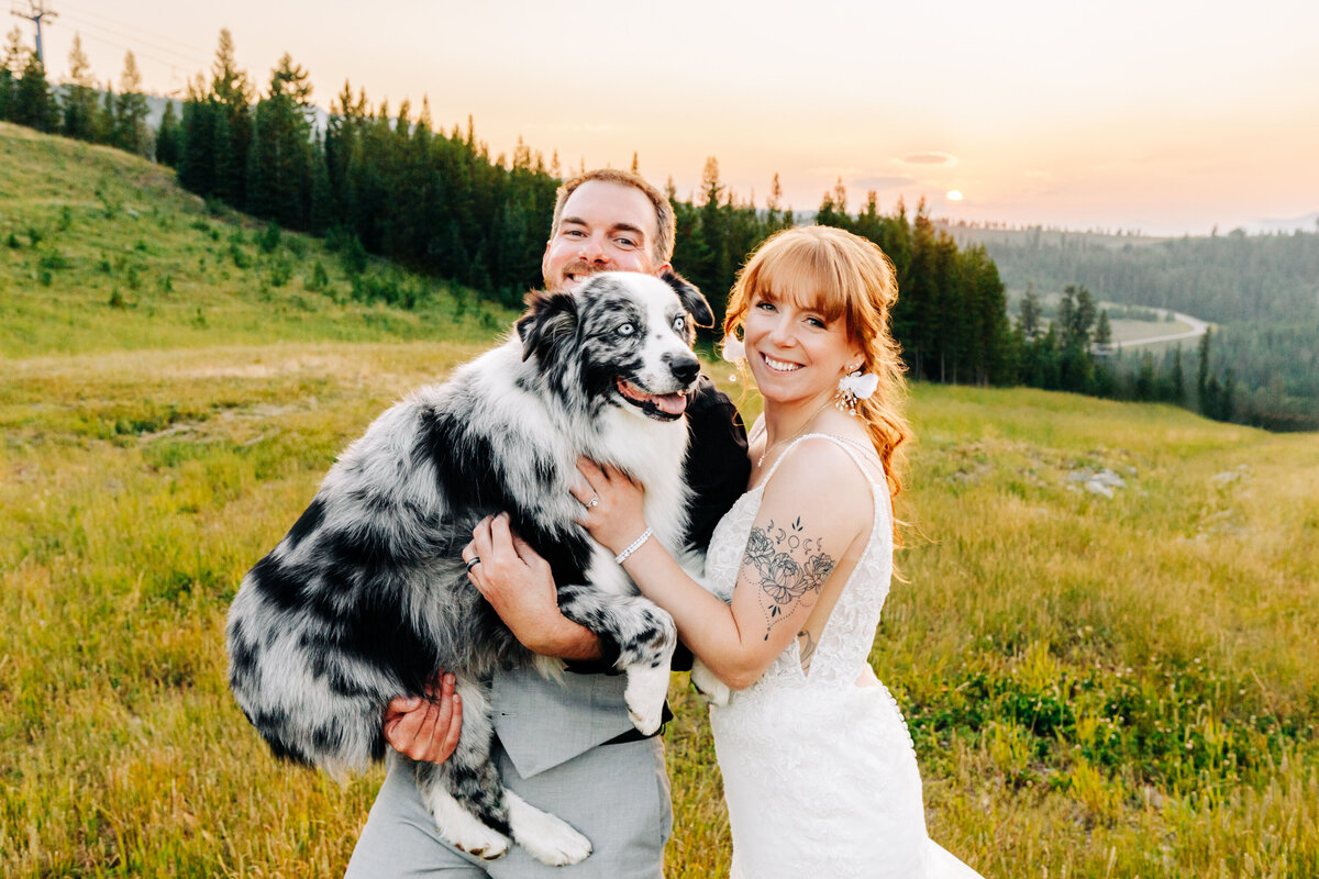 Sunset portrait of bride and groom with dog at Big Sky Resort, Montana