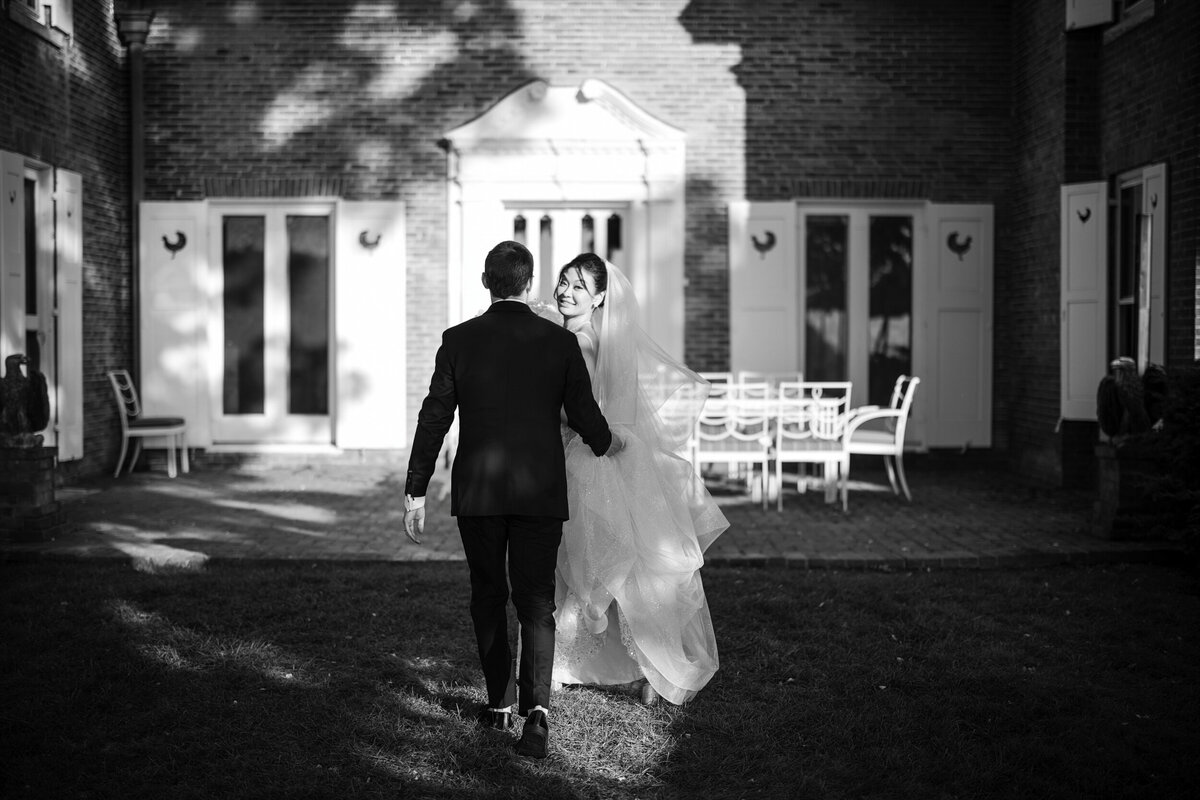 A couple walk away from their ceremony at a destination wedding in Vermont