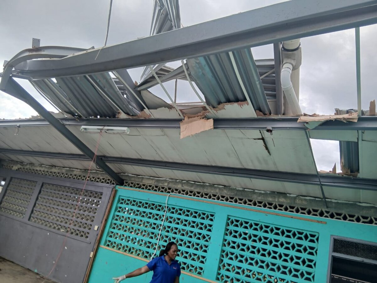 Collapsed roofing hanging over the classroom entrance area after the storm.