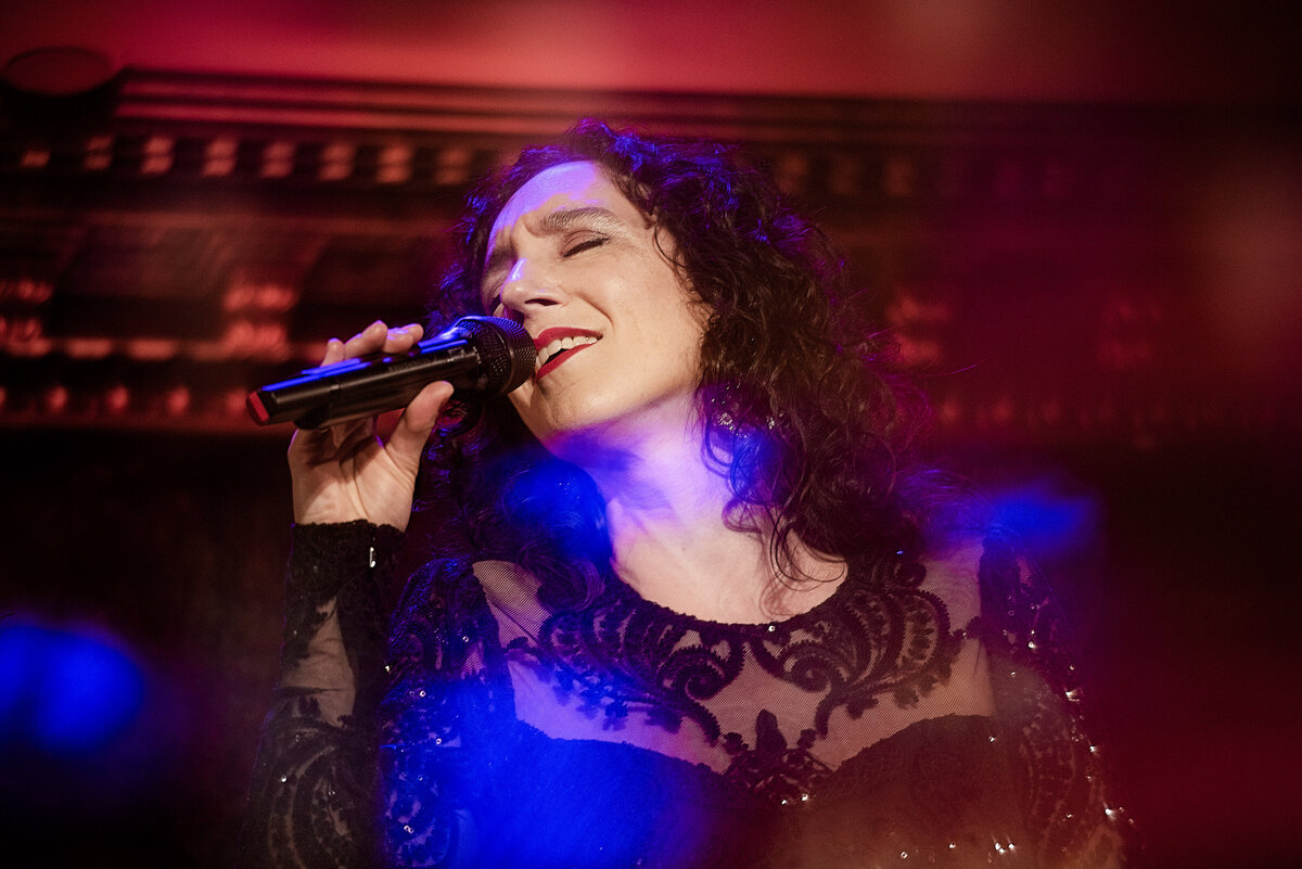 A woman singing on a stage