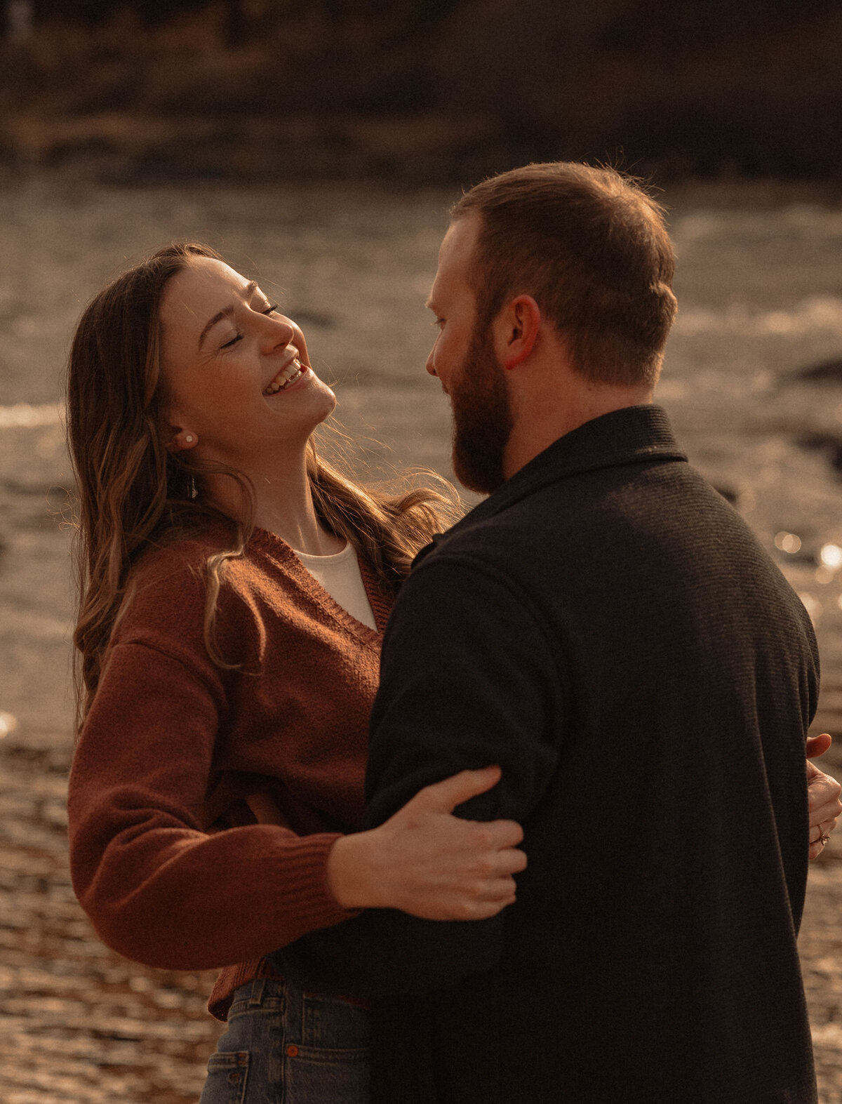 couple embracing and laughing near the river in Bend, Oregon