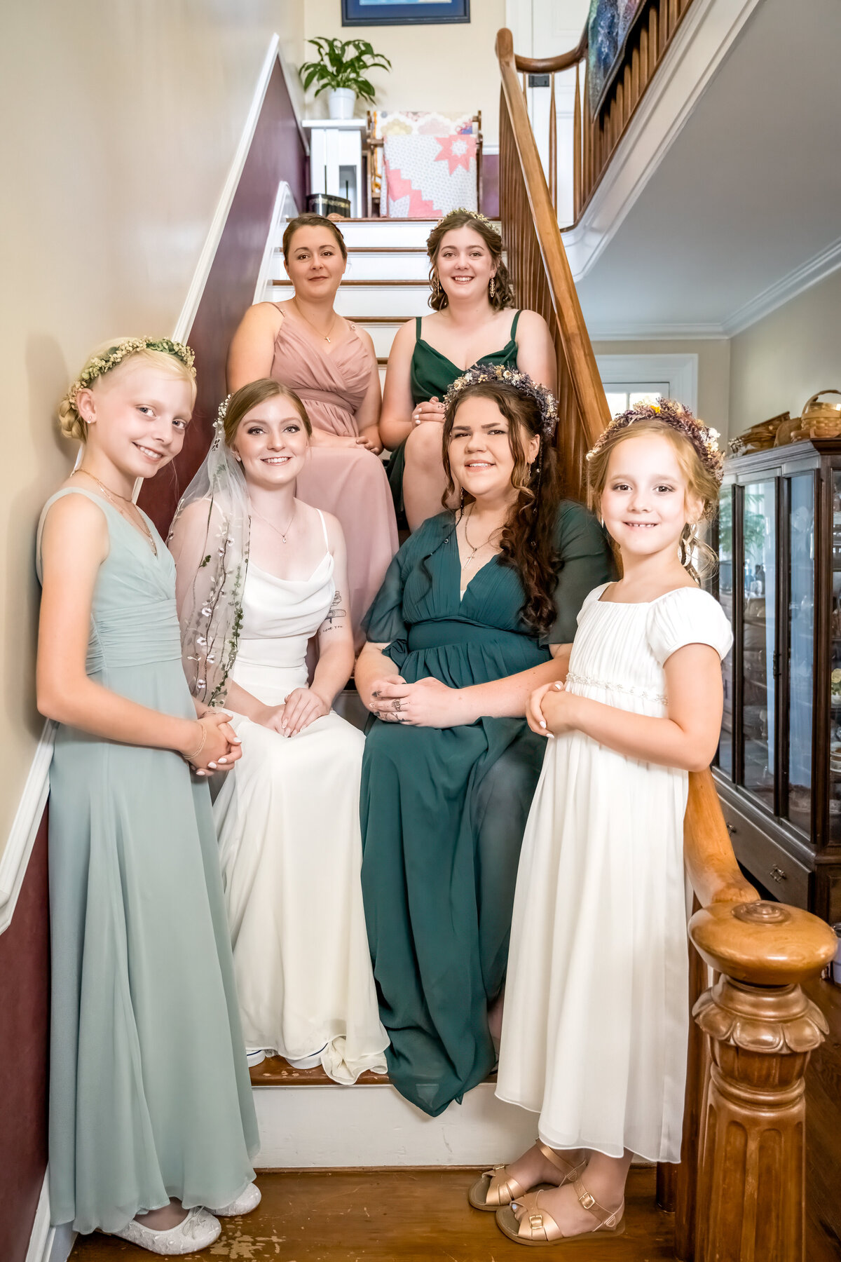 Bride with her bridesmaids on staircase