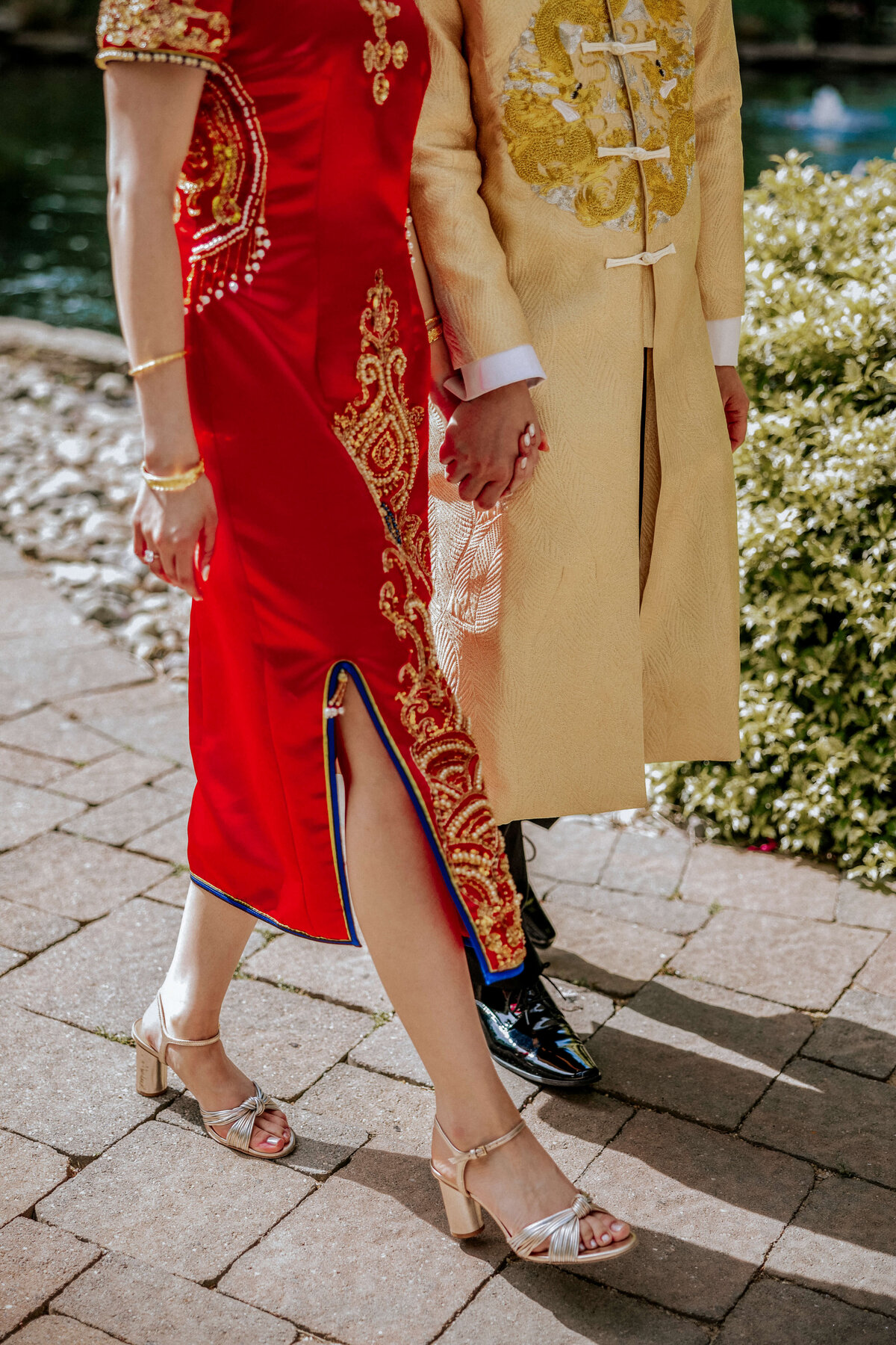chinese-bride-wearing-red-qipao-dress-walking-with-groom-in-gold-tang-suit