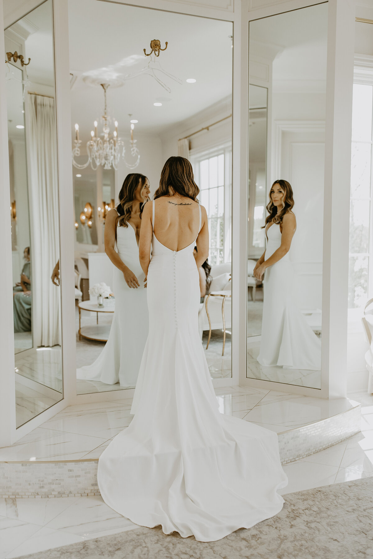 Wedding Photographer & Videographer, bride standing in front of mirror