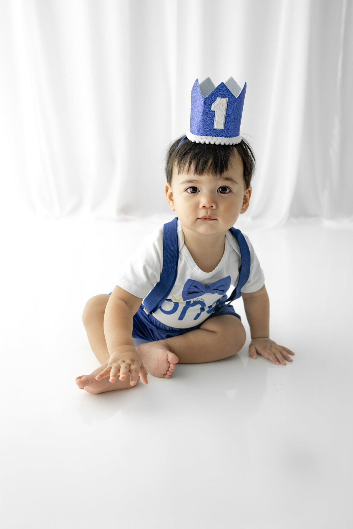 Boy in birthday outfit during themed cake smash session— captured by Alliston and Barrie cake smash photographer.