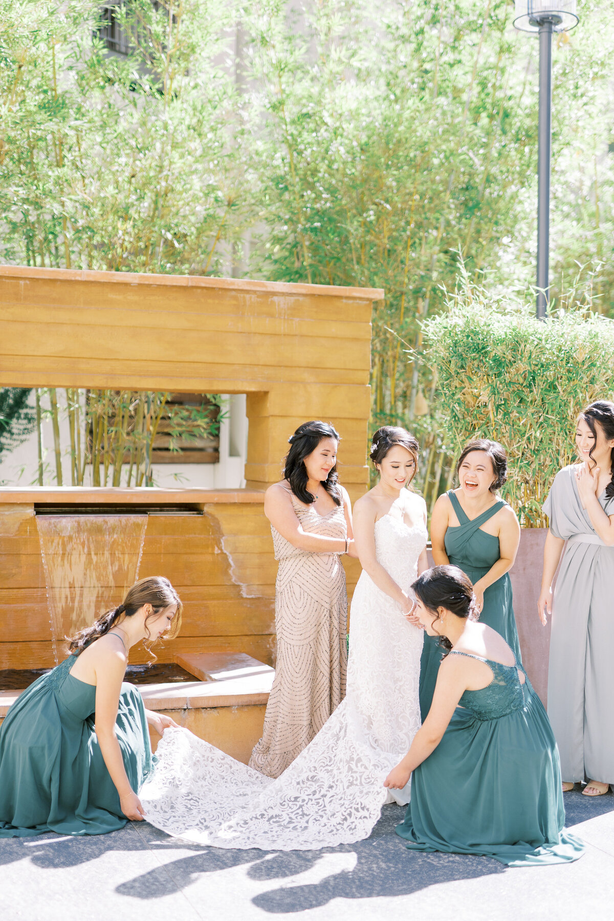 bridesmaids helping bride get dressed