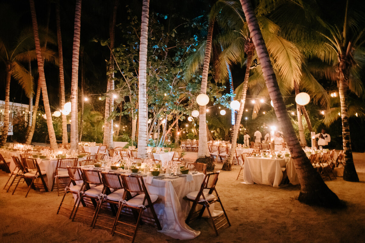 Wedding seating under the coconut groves with lanterns in the Bahamas