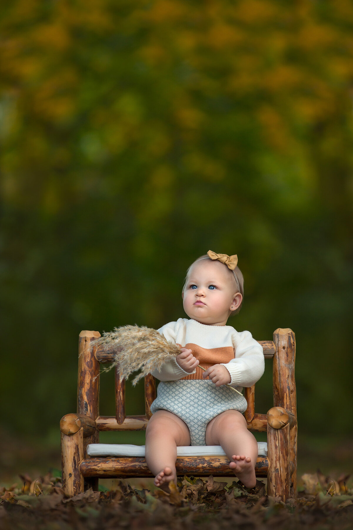 child sits on a bench during an outdoor family photography session in Mount Holly, New Jersey