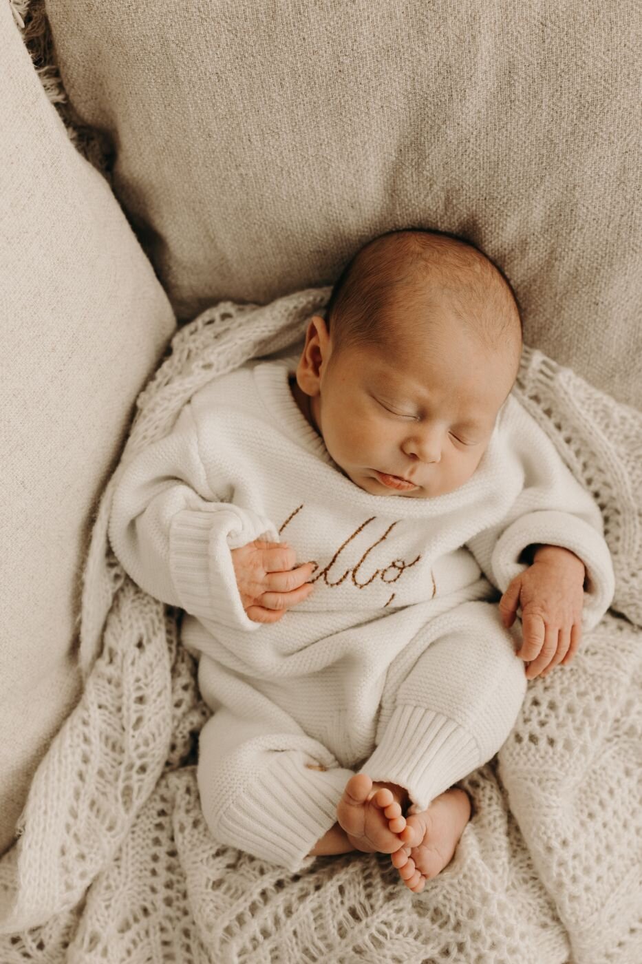 Beautiful sleeping newborn baby in a cozy white outfit during a Mullingar photoshoot