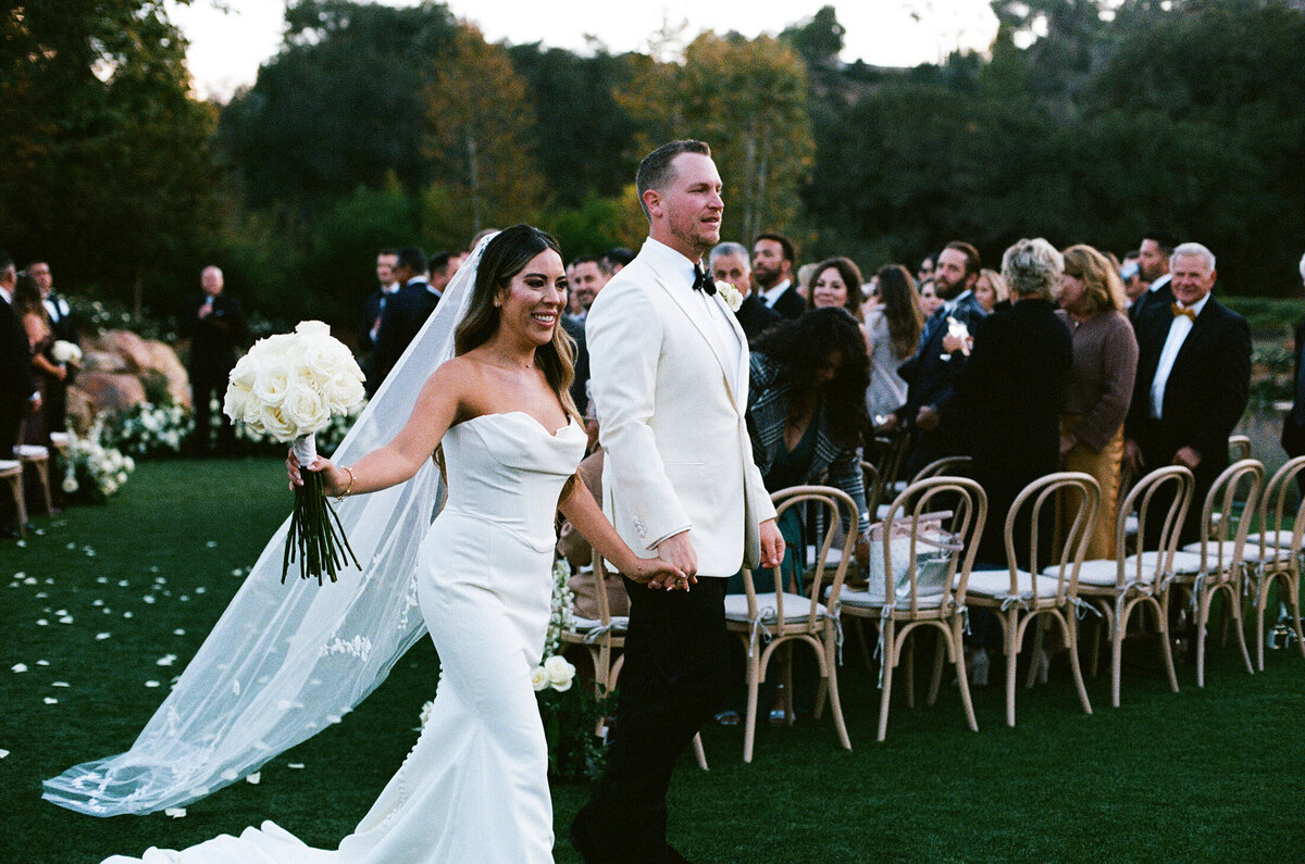Bride and groom walking down aisle shot on 35mmfilm