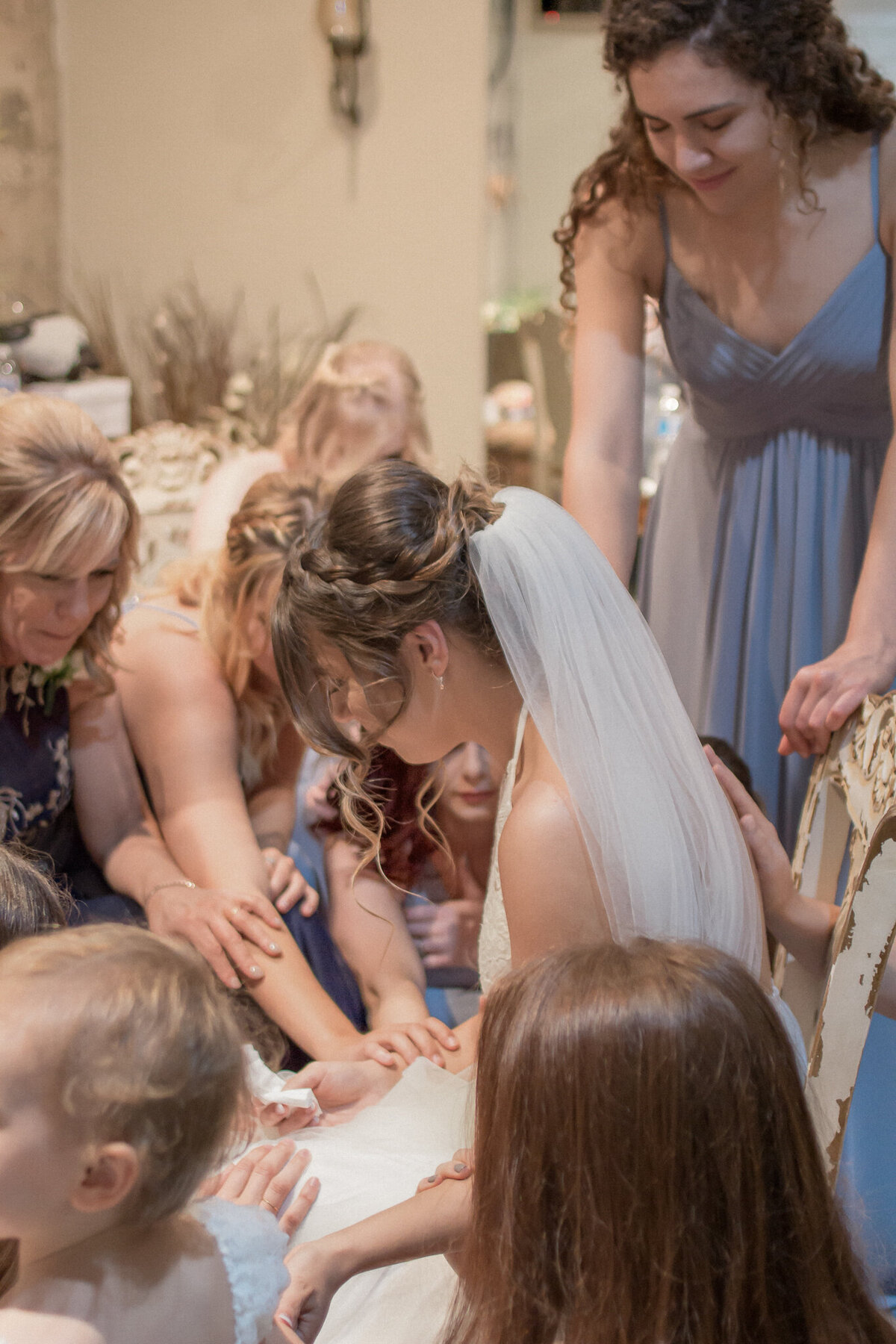 Lindsey's bridesmaids and family surround and pray for her moments before she walks down the aisle