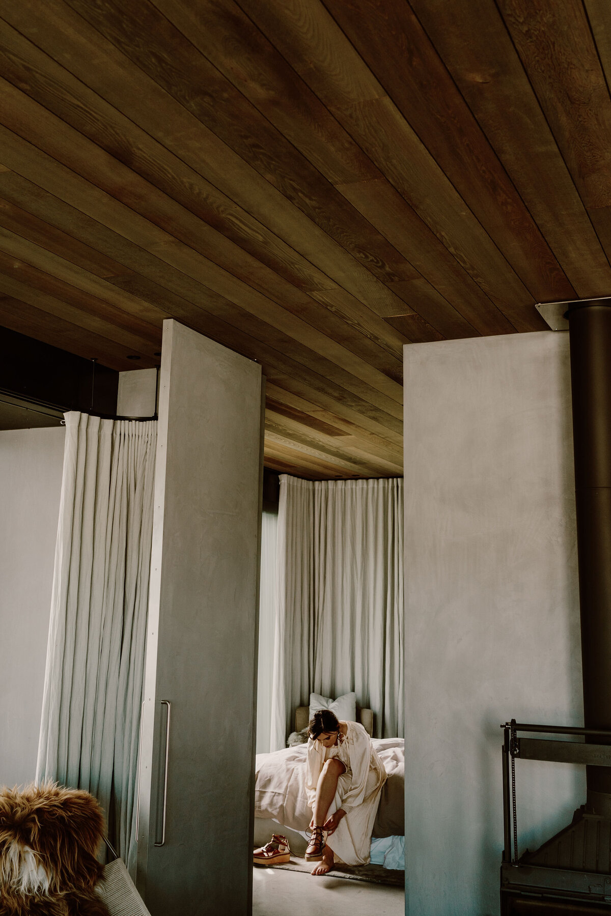 The Lovers Elopement Co - bride gets ready for wedding in stunning room with high ceiling in Queenstown