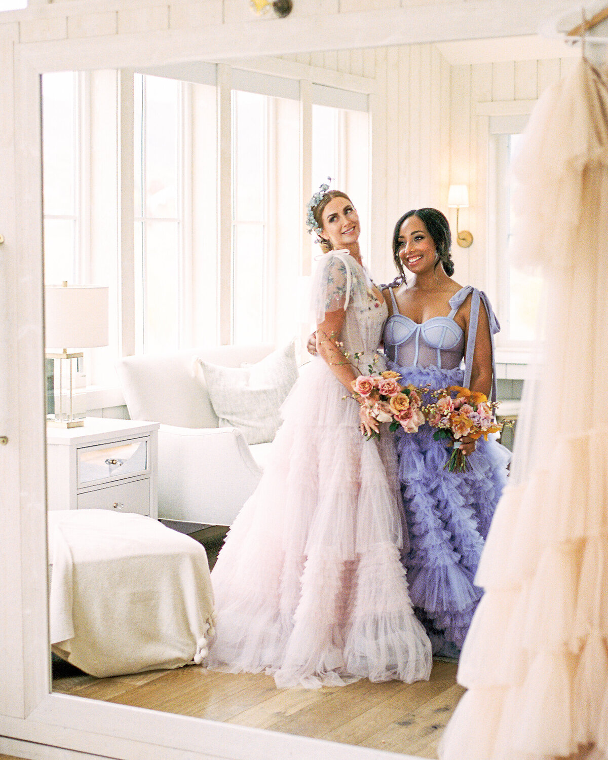 Bride and bridesmaid look in the mirror and smile